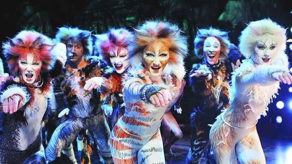 A still from the musical cats. Performers wear stylized dance outfits with cat ears and tails, and are wearing cat makeup. 